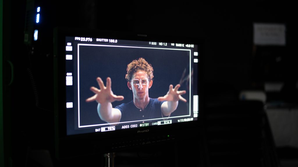 Camera monitor showing a performer mid-take